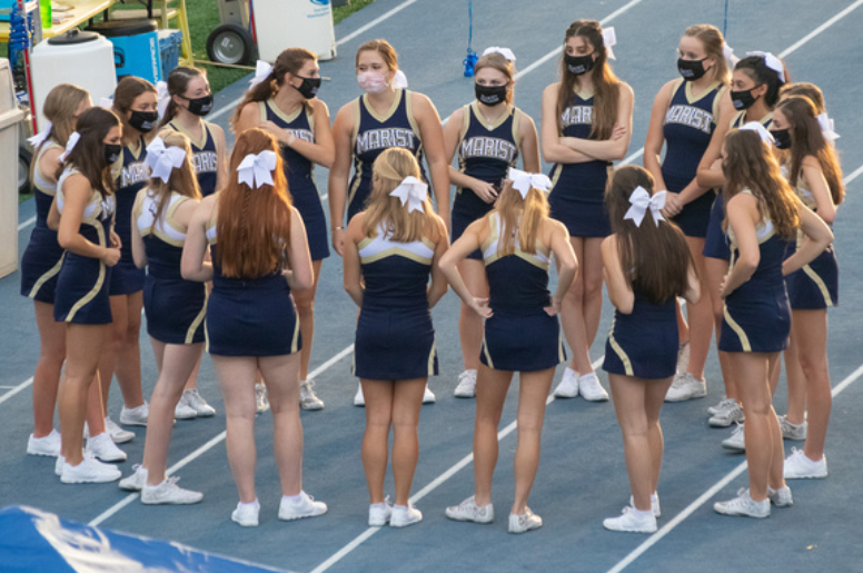 The Varsity Cheerleaders sport their Marist Cheerleading masks at every football game