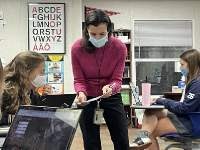 Yearbook staff members and moderator Christine Bhasin working together on pages for Guidon.