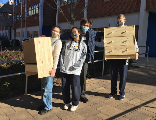 Marist juniors and seniors assemble dressers for the furniture bank as part of the Galilee retreat.