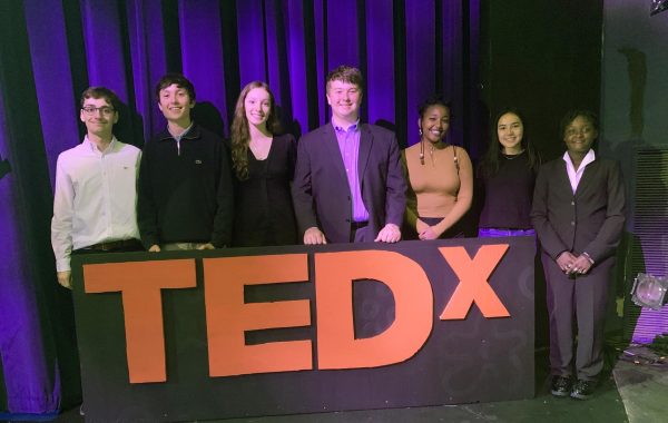 TEDx speakers gather on the stage before presentation begins.