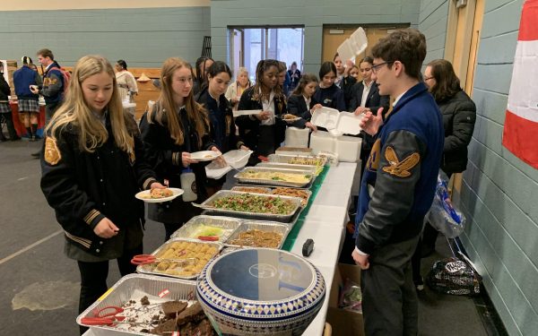 Several students enjoy traditional Lebanese food during the Global Fair hosted by Share the Journey. 