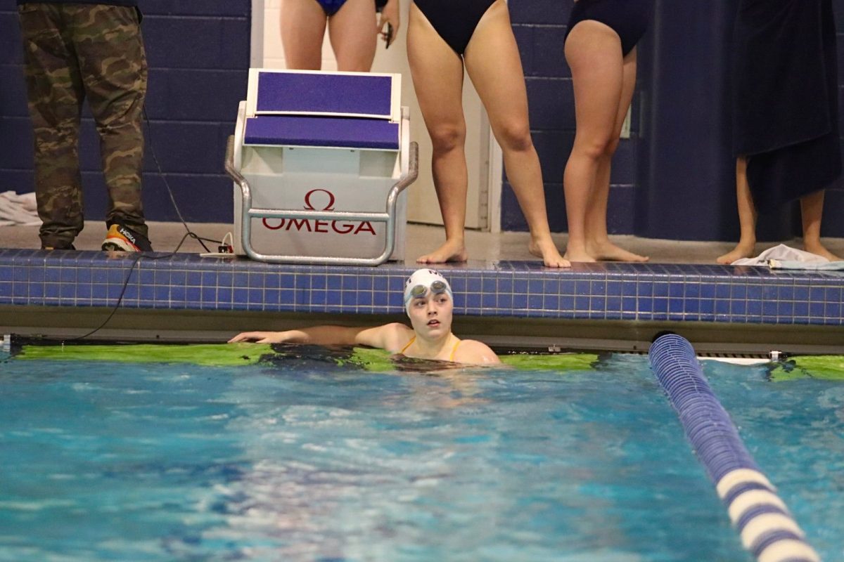 After swimming the 200 free, Caroline Schaffer checks out the scoreboard.