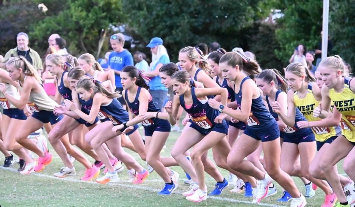 Marist girls begin their two mile race in their brand new pink and navy uniforms.