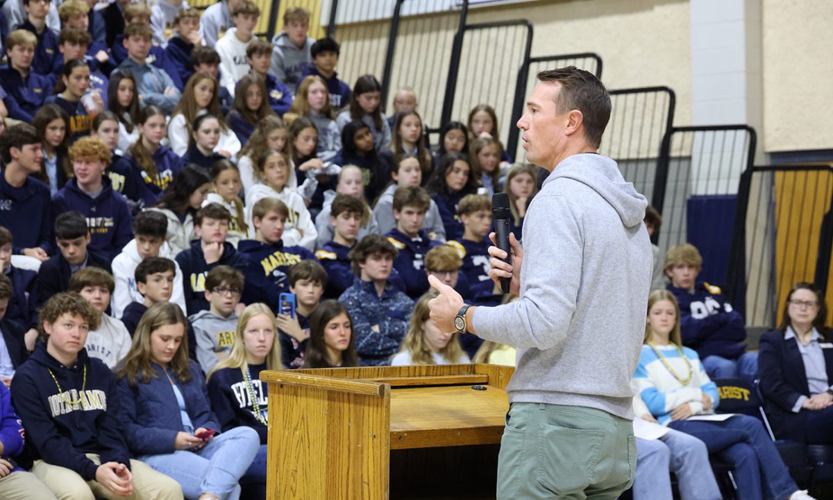 Former Atlanta Falcon Matt Ryan addresses the student body during a Friday morning FCA meeting. Guest speakers such as Ryan drew the largest FCA crowds in school history.