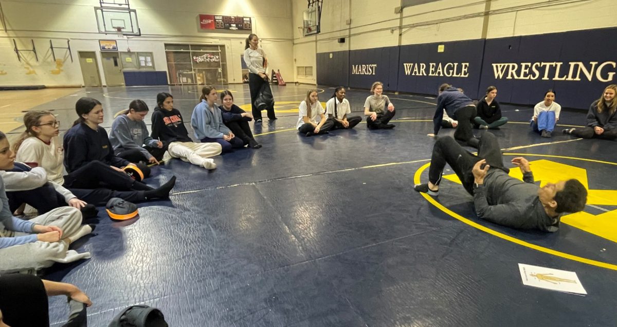 Students gather around Mr. Kennedy to listen to his important messages and learn basic self-defense skills. (Photo Contributed)