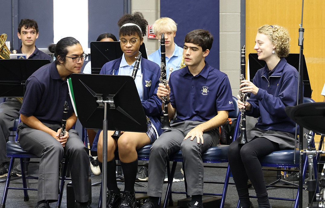 Members of music ministry look over their song sheets before Mass begins. (Photo Credit: Brian Collier)