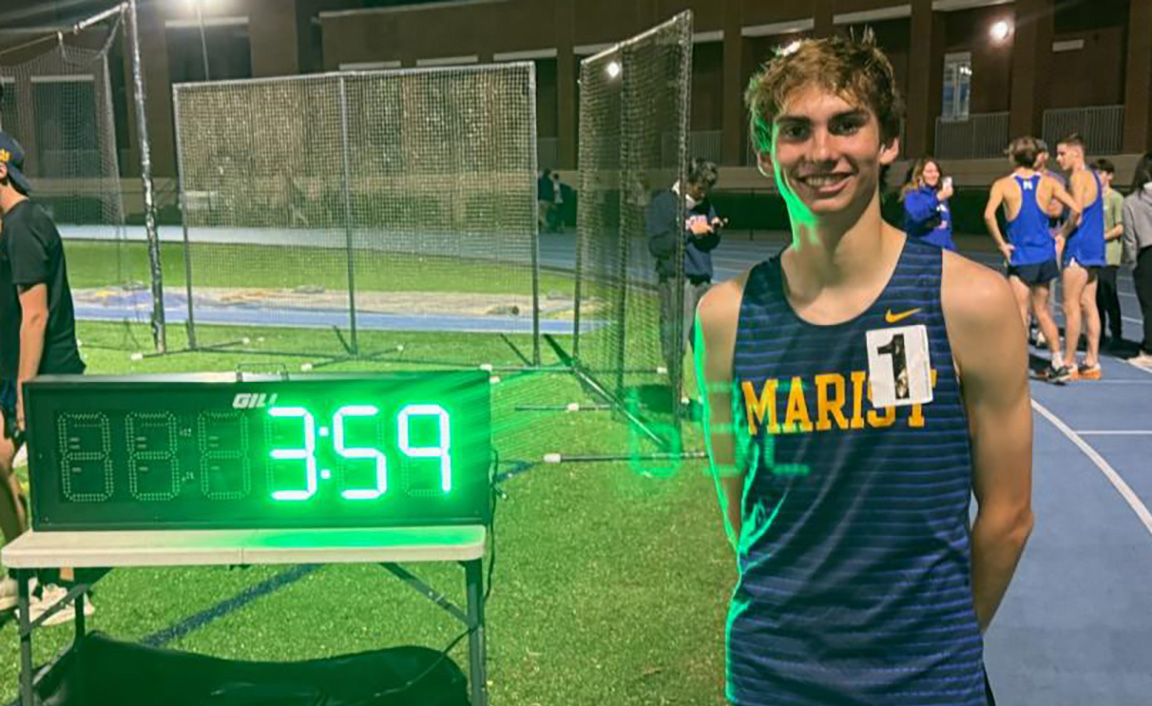 Tommy Latham marks his historic performance with a picture next to the race clock. (Photo Credit: Tom Reim)