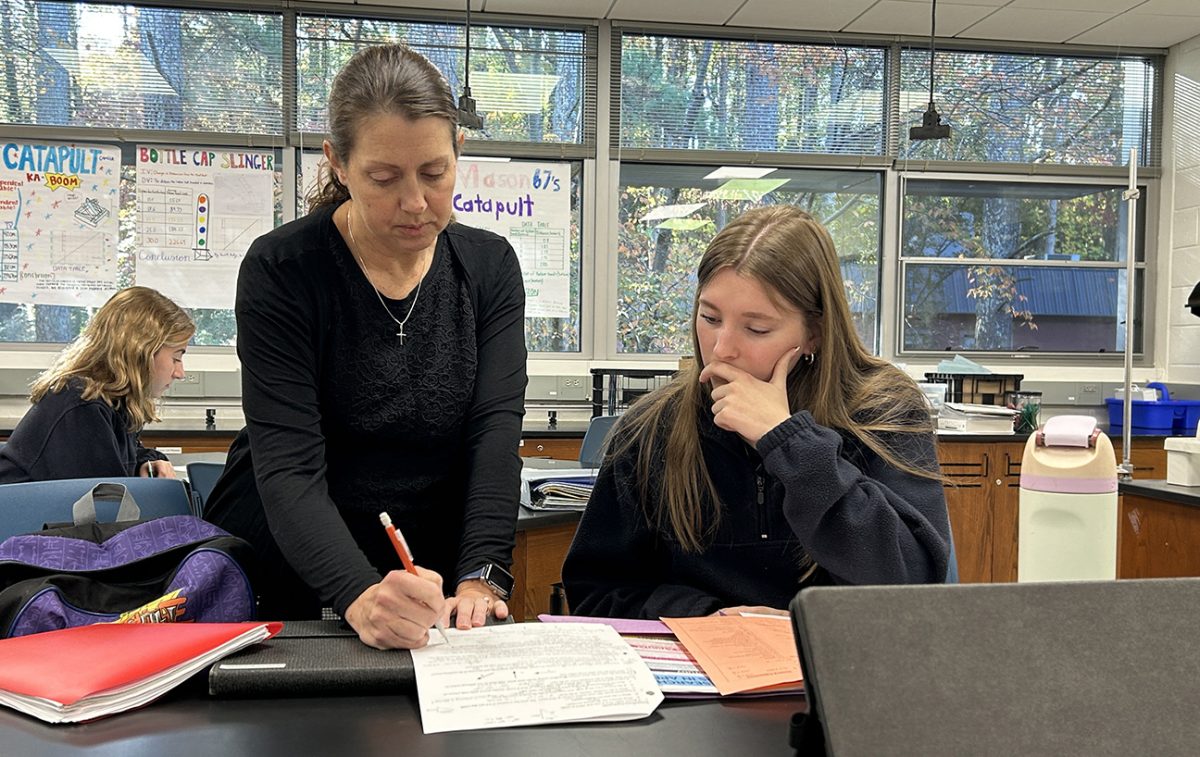 Science teacher Emilie Cross works with student Kelly Hagearty during the extended tutorial prior to the exam. (Photographer: Brian O'Connor)