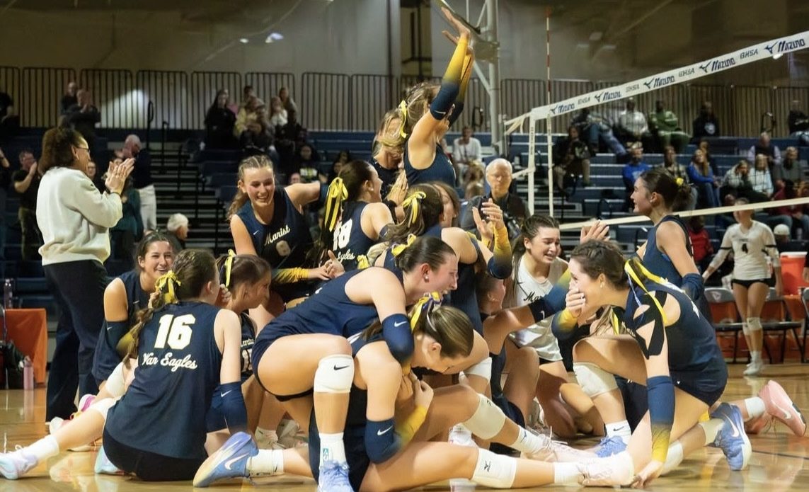 The varsity volleyball team celebrate the final point that captured the state championship. (Photo Contributed)