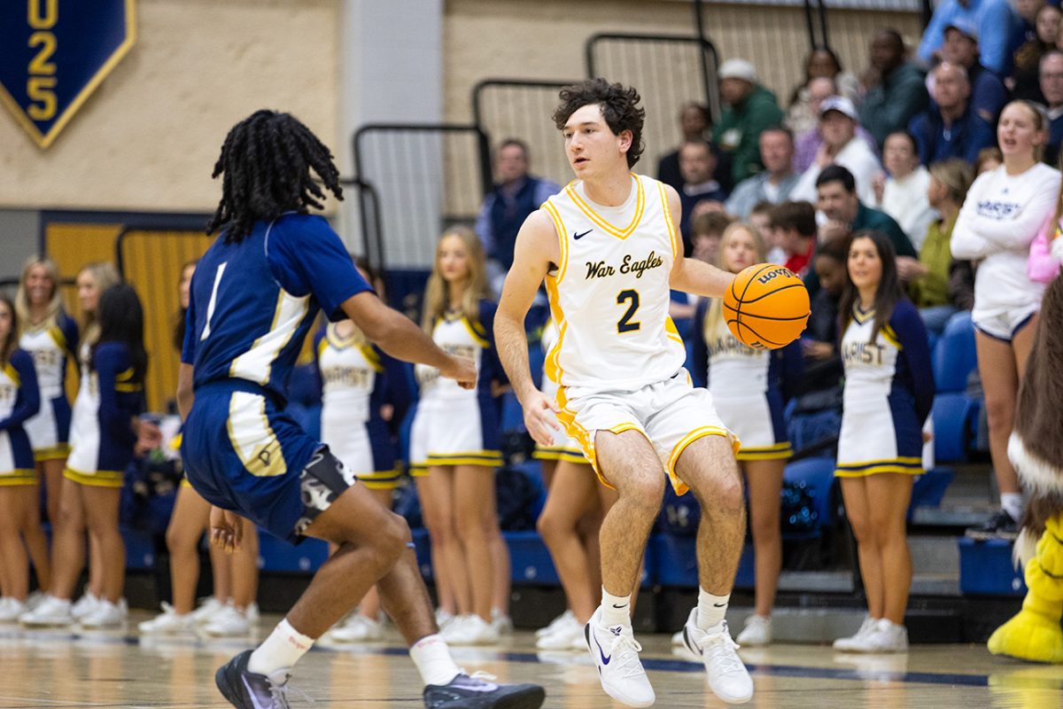Engin McCarthy drives the ball down the court towards another basket. (Art of Life Photography)