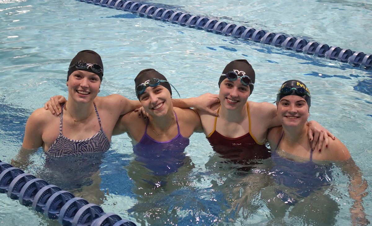 Several members of the girls swim team pose for a photo. (Collier)