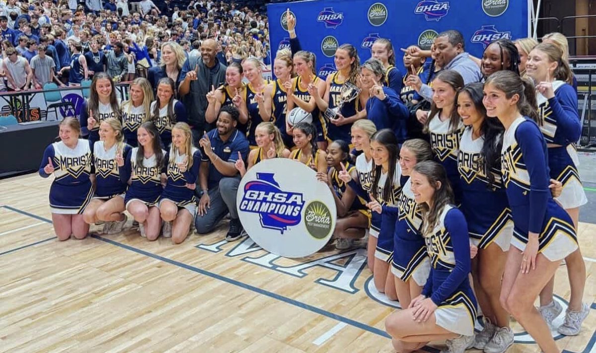 The girls basketball team and cheer squad gather for a photo on the floor of the Macon Centreplex. (Contributed)